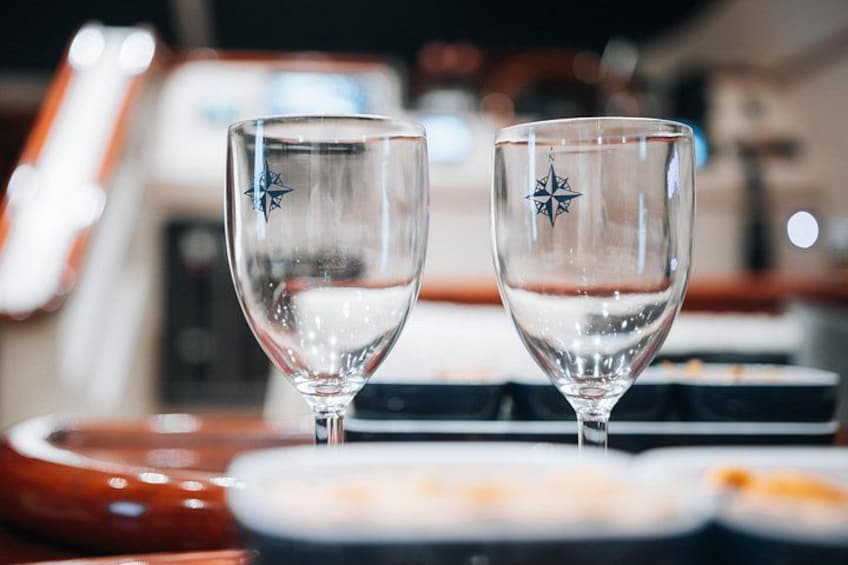 Two empty wine glasses with star designs on a table. 2
