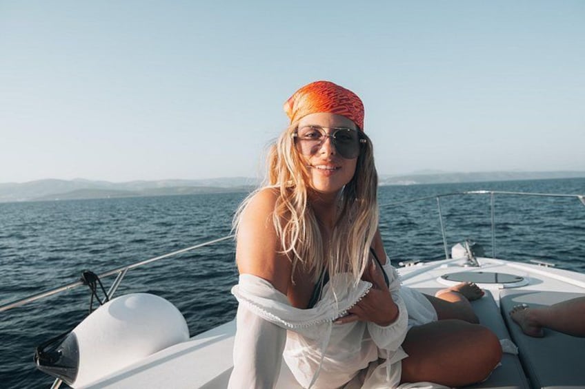 A person on a boat with a clear view of the ocean and distant land. 5