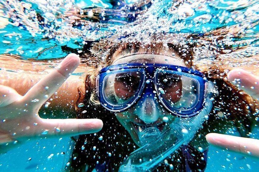 A person underwater with bubbles, wearing a snorkel and goggles. 4