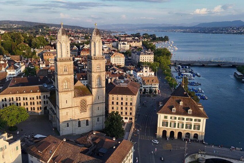 A cityscape with a prominent church, a waterfront, and a bridge. 2