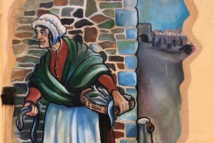 Une fresque représentant une personne vêtue d’un costume traditionnel, un mur de pierre et une tour. 3
