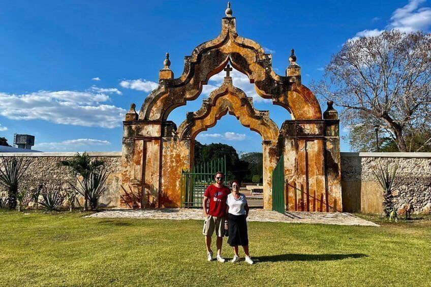 A historic archway with two people standing in front. 2