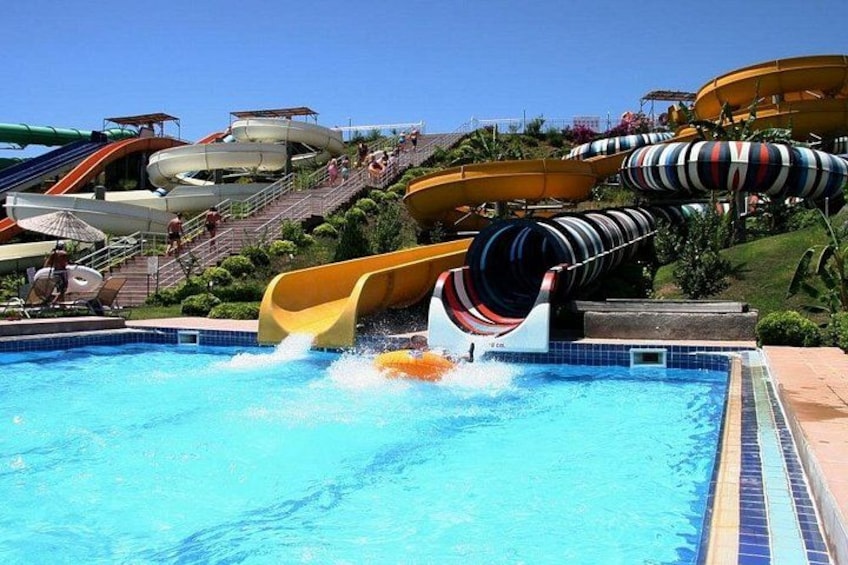 Een waterpark met verschillende glijbanen en een zwembad. 4