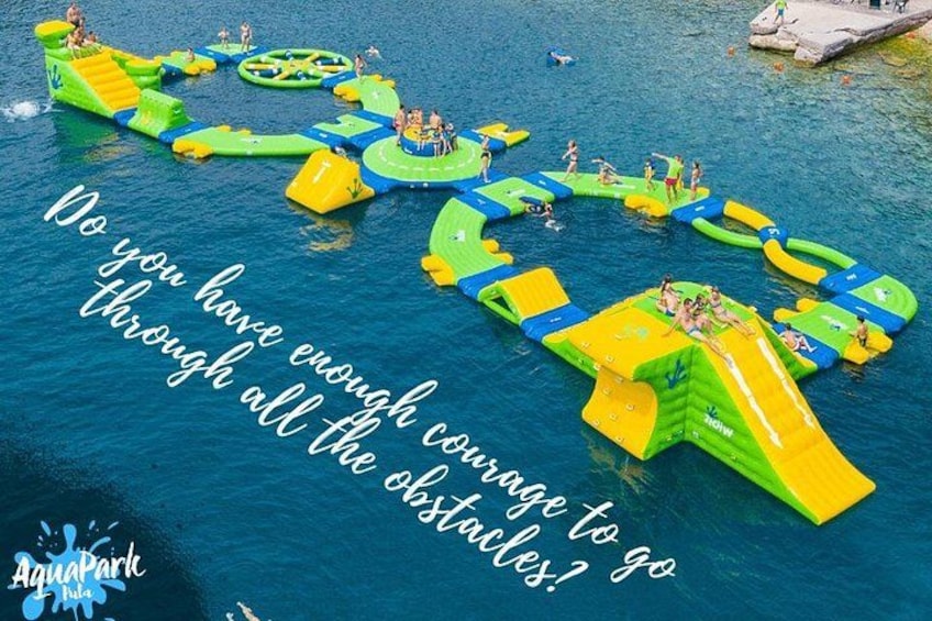 An inflatable obstacle course on water with people participating. 1
