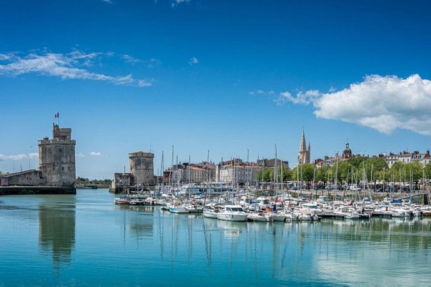 A harbor with boats, a castle, and a church. 1