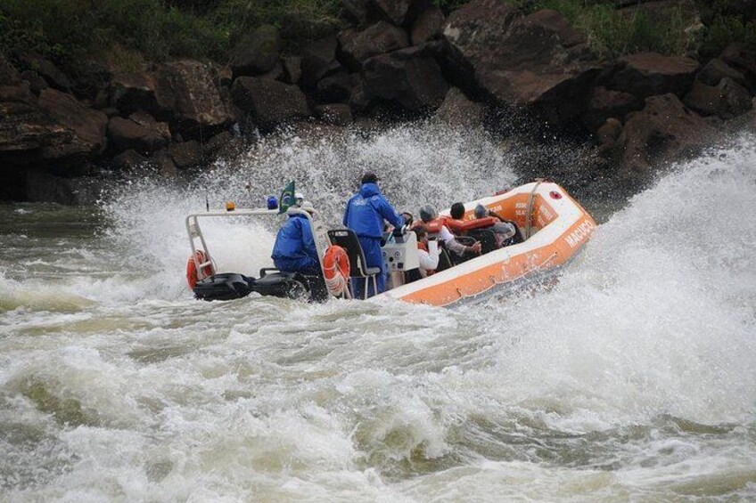 A white and orange inflatable raft navigating through turbulent river waters. 5