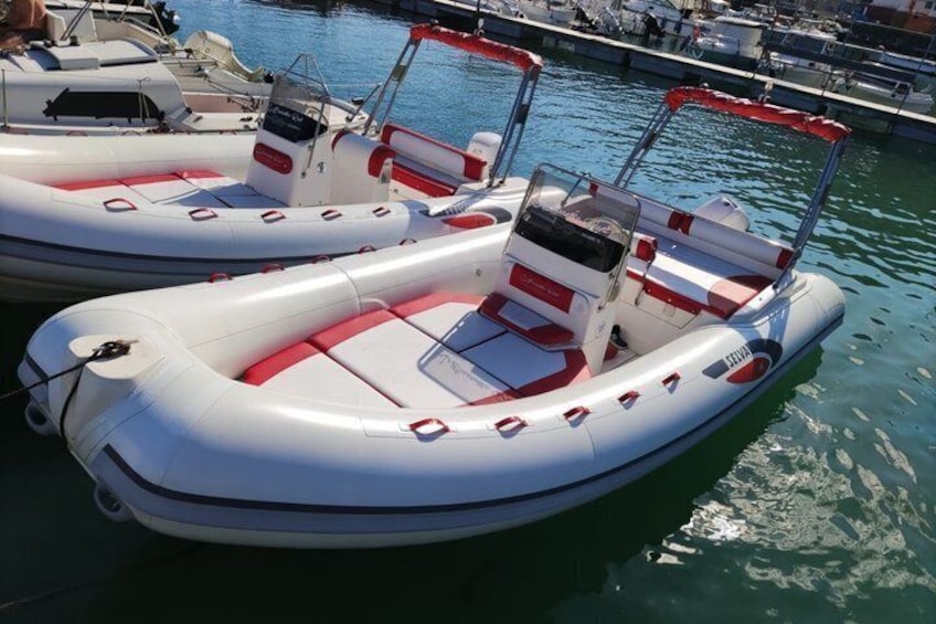 Two inflatable boats docked at a marina. 3