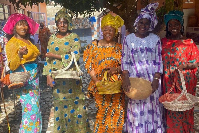 A group of people in colorful traditional attire, some holding baskets. 5