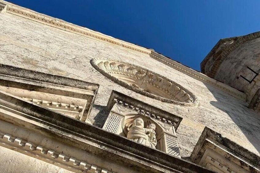 A detailed stone facade with carvings and inscriptions. 3