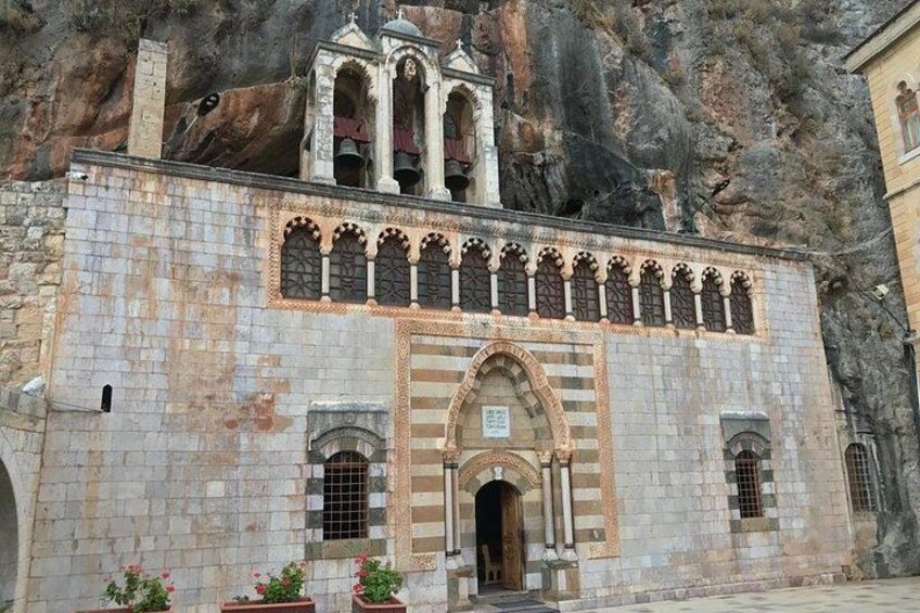 A historic building with a bell tower, arched windows, and a stone facade. 2