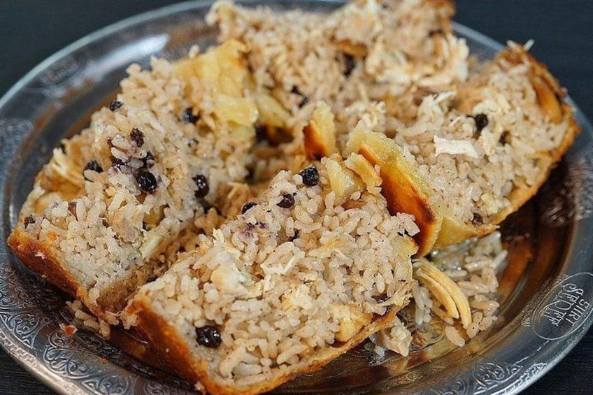 A plate of sliced bread with a filling of rice, raisins, and possibly nuts. 3