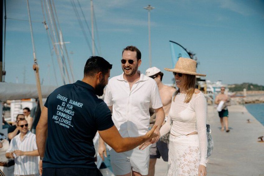 A group of people on a pier with boats in the background. 5
