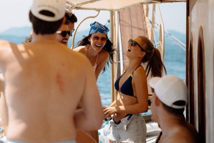 People on a boat with a mountainous landscape in the background. 5