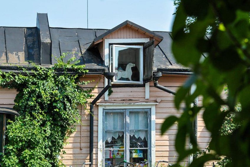 A house with a dormer window, a visible chimney, and a window with a curtain. 2
