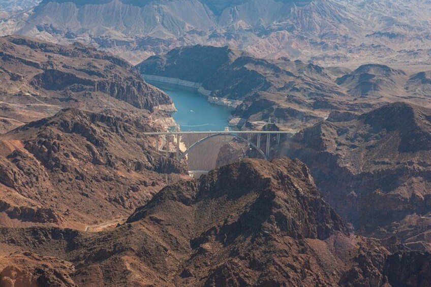 A mountainous landscape with a dam and reservoir. 2