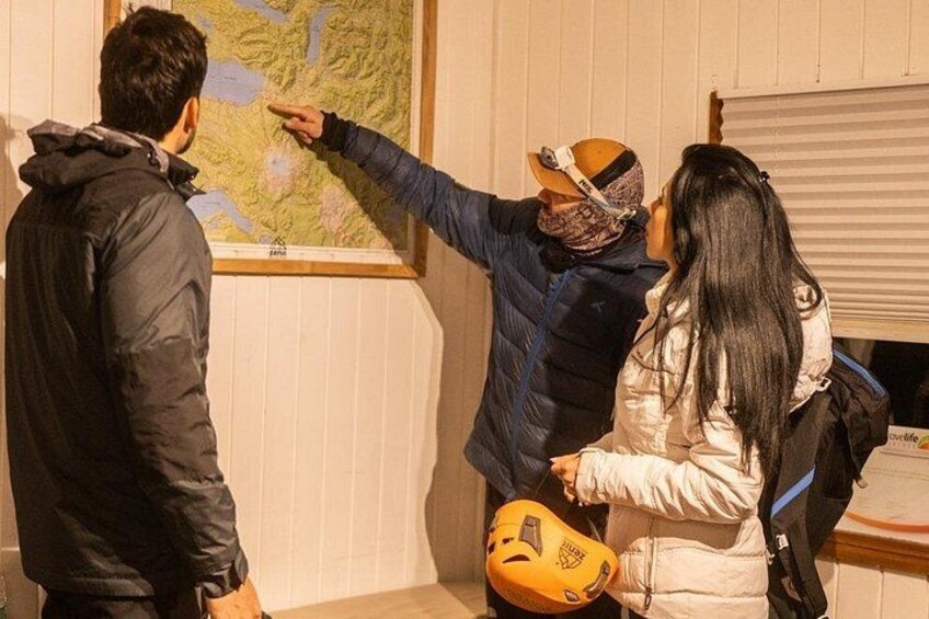A group of people examining a map. 3