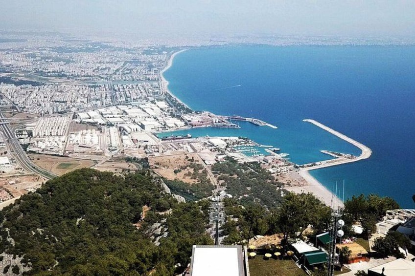 A coastal cityscape with a marina, a beach, and a dense urban area. 2