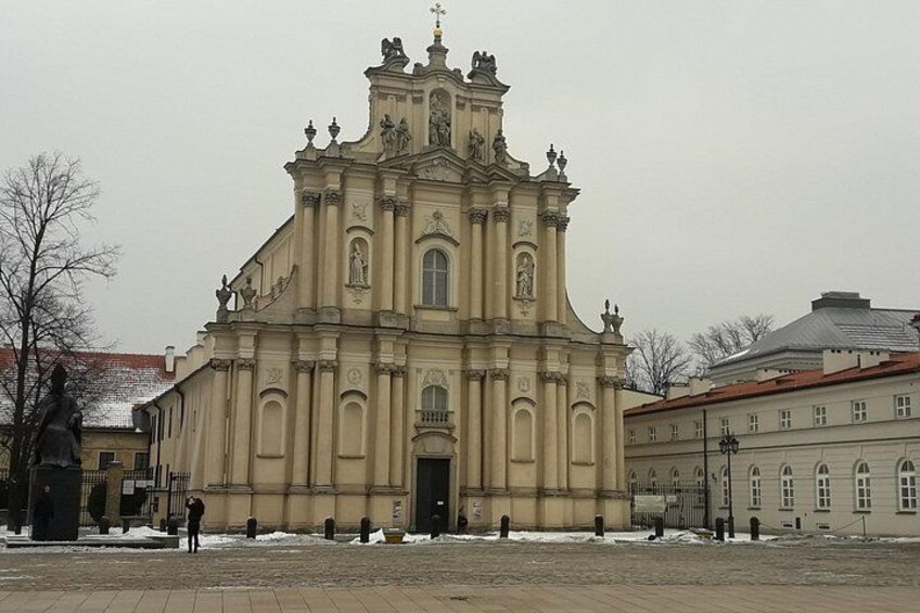 A large, ornate church with a central dome and multiple statues on its facade. 2