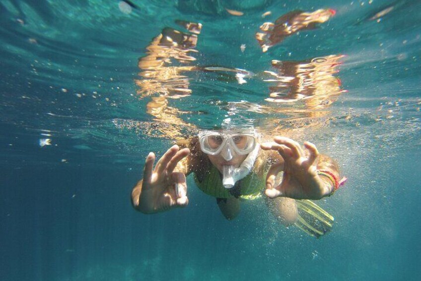 A person swimming underwater with snorkel and fins. 5
