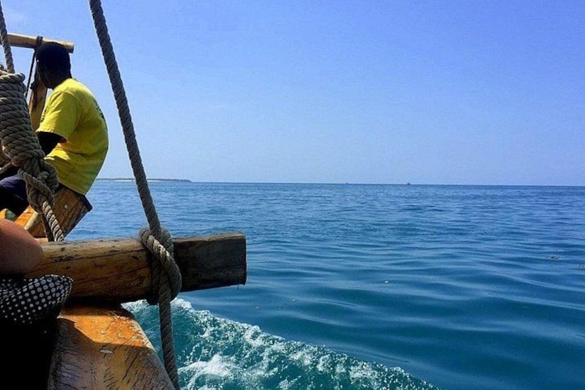A wooden boat with ropes, a person in a yellow shirt, and calm blue sea. 1