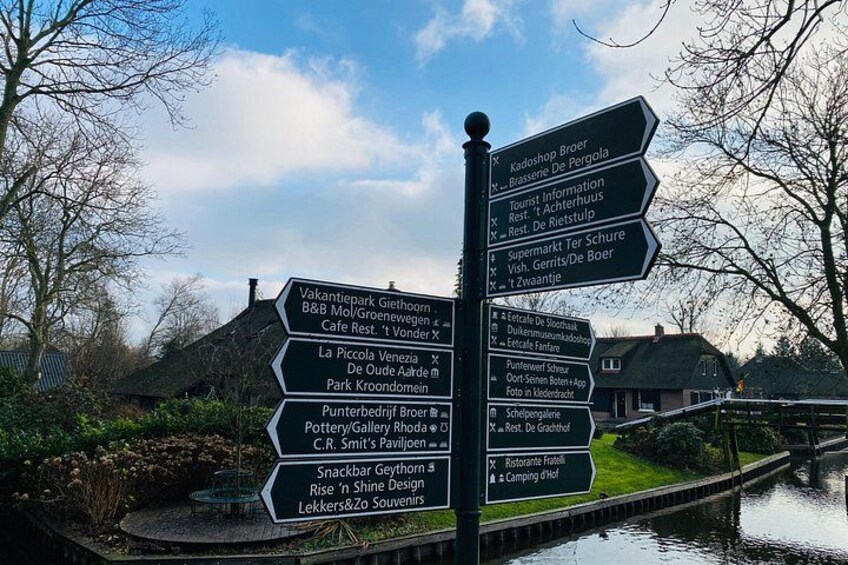 Un panneau indicateur directionnel avec de nombreuses flèches pointant vers différents lieux d’intérêt et différents services à proximité. 5