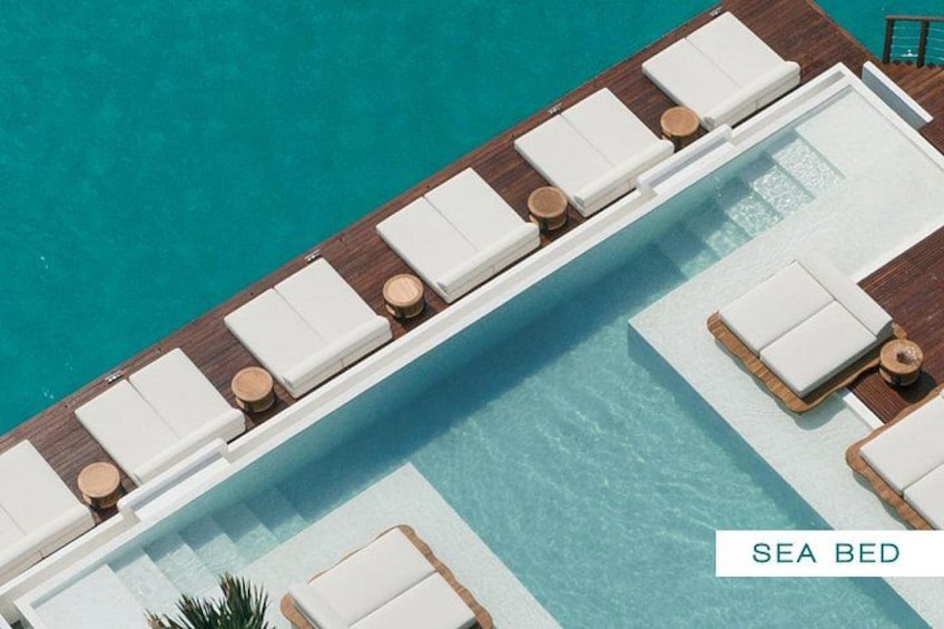 A sea bed with lounge chairs and a pool. 4