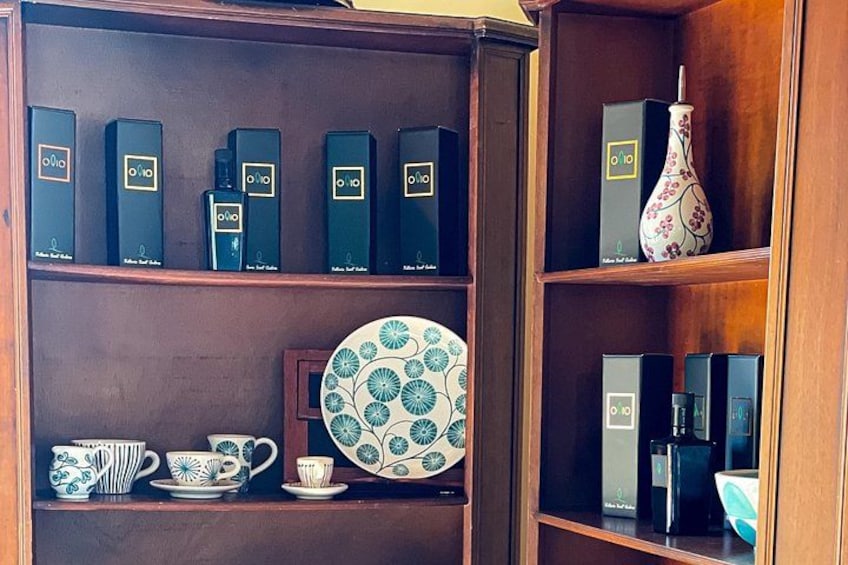 A display of products on shelves, including boxes and a vase. 2