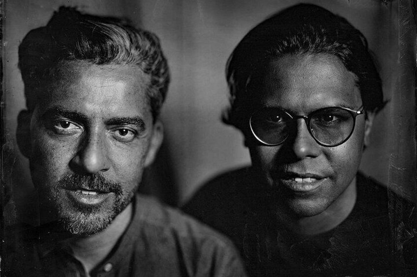 Two individuals in a dimly lit setting. 2