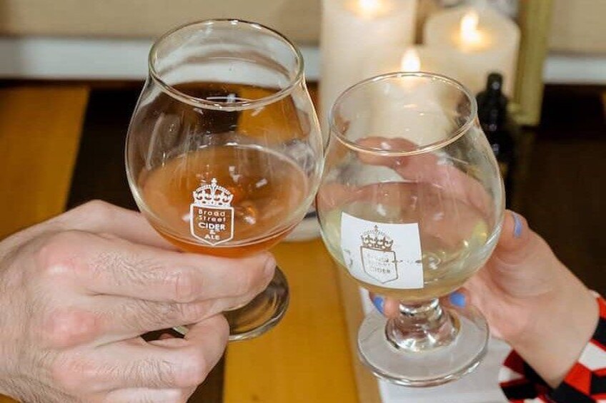 Two hands holding glasses of beer, one with a crown logo and the other with a shield logo. 3