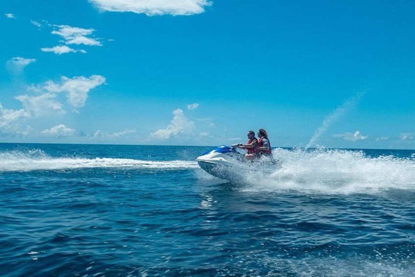 A jet ski with two people on the water. 5