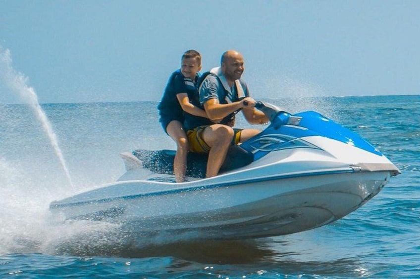 Two people on a jet ski in the ocean. 4