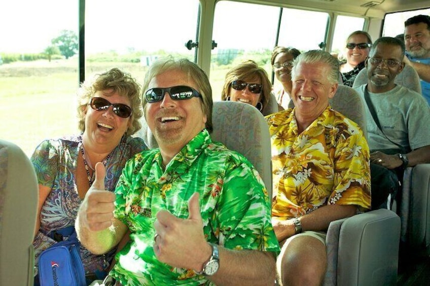 People seated in a vehicle with a landscape visible through the windows. 3