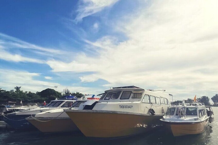 Several boats docked at a marina with a clear sky. 3