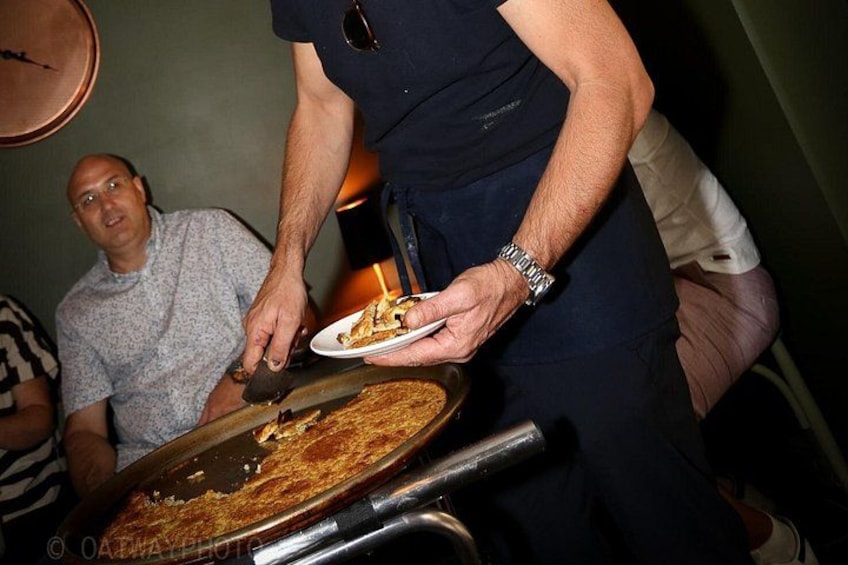 A person serving pizza on a white plate. 3