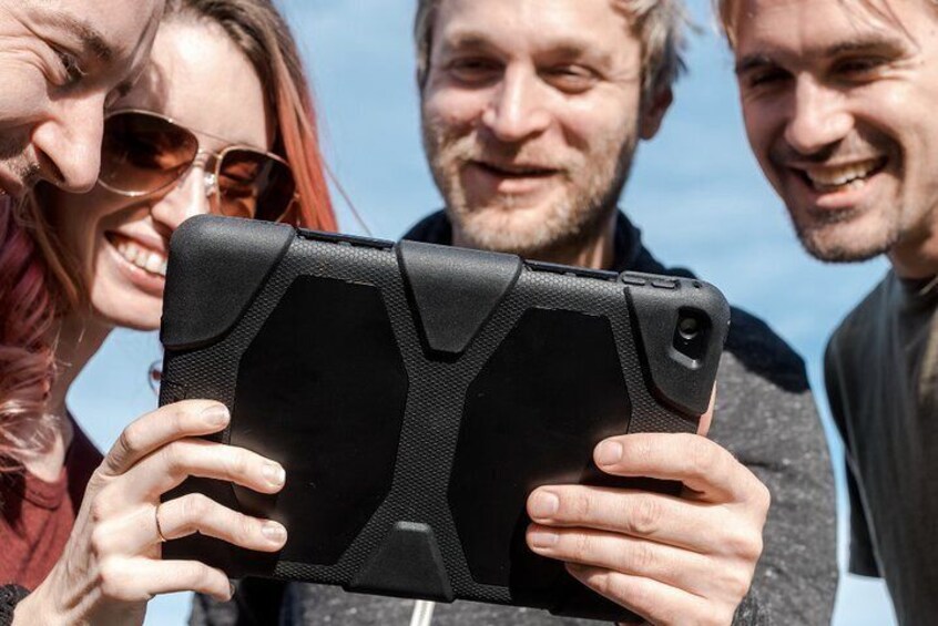A person holding a tablet with a rugged case. 1