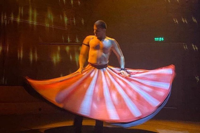 A person performing with a flowing red and white fabric. 2