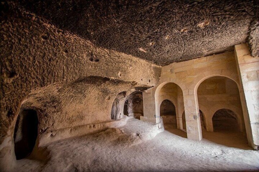 Eine uralte Höhle mit gewölbten Gängen und rauen Steinwänden. 1