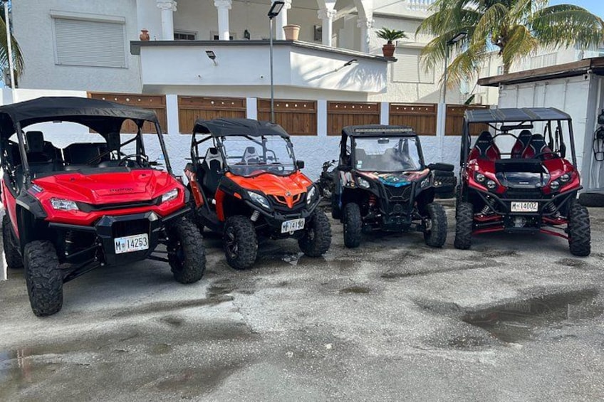 Four off-road vehicles parked in a line. 1