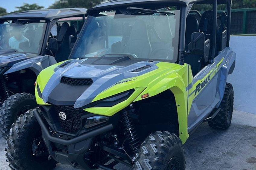 A yellow and gray off-road vehicle with large tires and a rugged design. 2