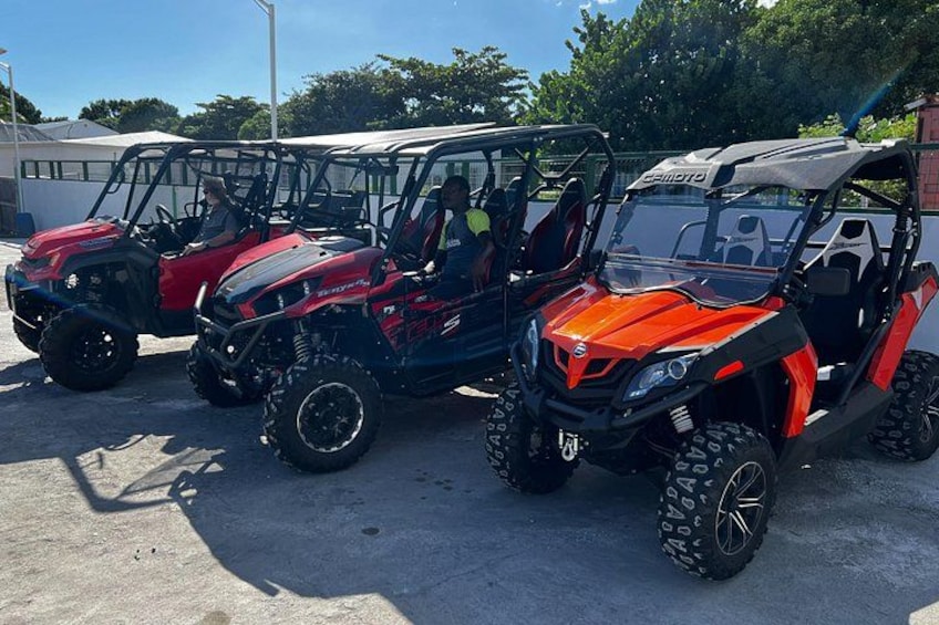 Four off-road vehicles parked in a lot. 4