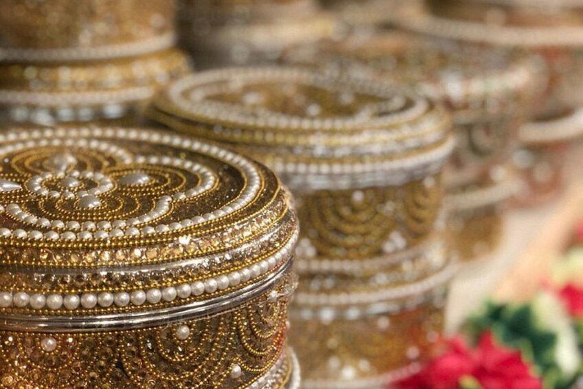 Intricately decorated containers with pearl embellishments. 4