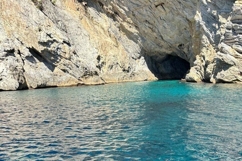 A coastal cave entrance with clear turquoise water. 2