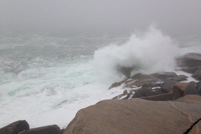 A rocky shoreline with waves crashing against the rocks. 3