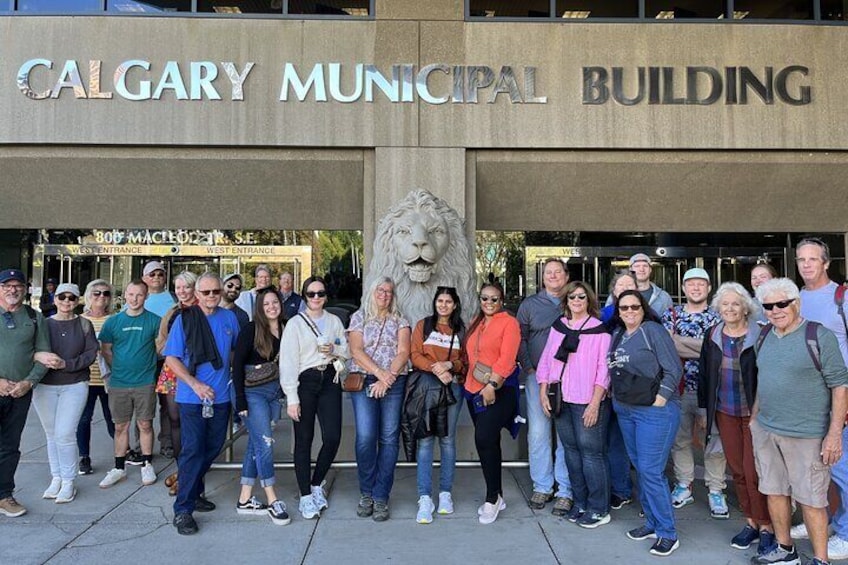 A group of people standing in front of the Calgary Municipal Building. 3