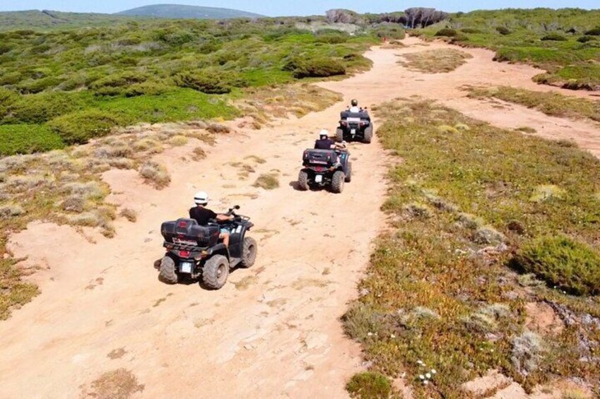 A dirt path with four off-road vehicles. 2