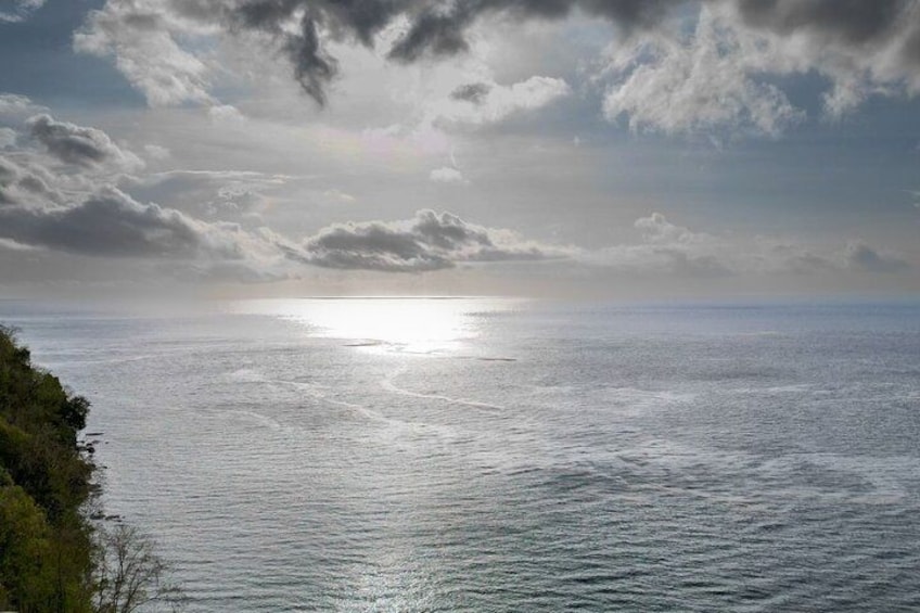 A coastal landscape with a view of the sea under a cloudy sky. 2