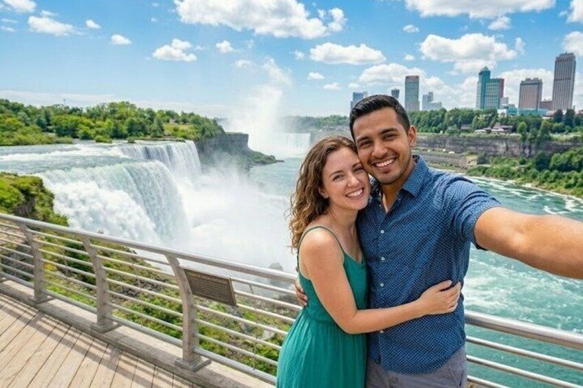 A couple taking a selfie with a waterfall and a city skyline in the background. 4