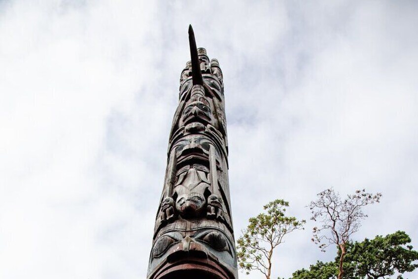 A tall, intricately carved stone monument against a cloudy sky. 4