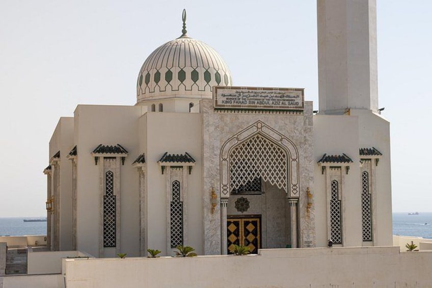 A mosque with a large dome and arched entrance. 5