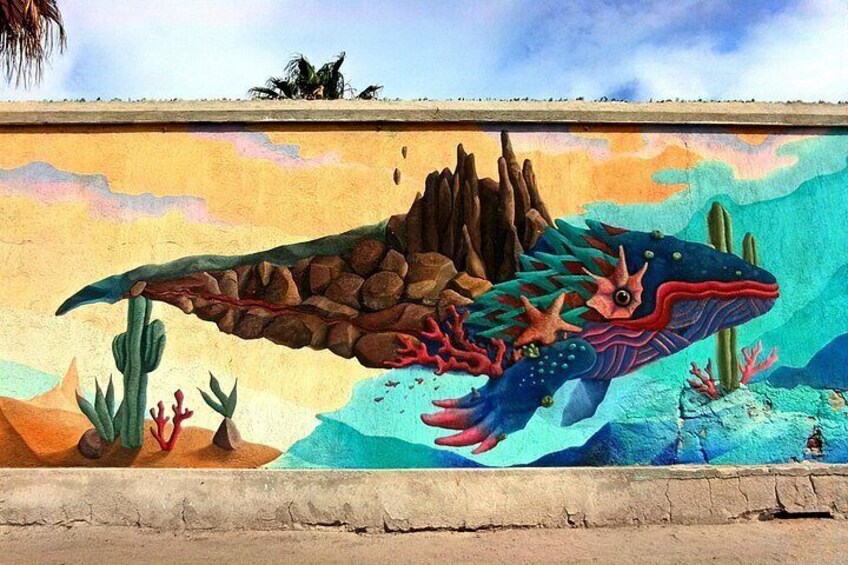 A mural of a colorful fish with a rocky backdrop. 1